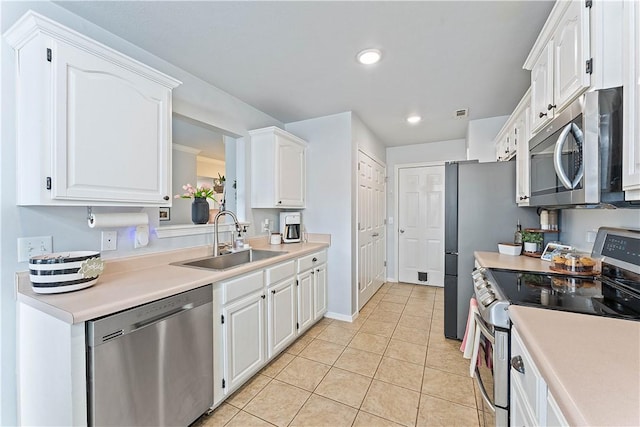 1031 Charles St, Pea Ridge, AR 72751 - kitchen with appliances with stainless steel finishes, a sink, white cabinets, light tile patterned flooring, and recessed lighting