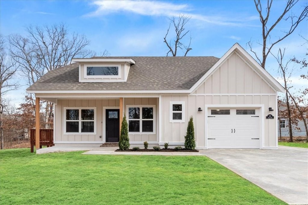 25 Coldstream Ln, Bella Vista, AR 72715 - view of front of property featuring board and batten siding, a shingled roof, an attached garage, a front yard, and driveway