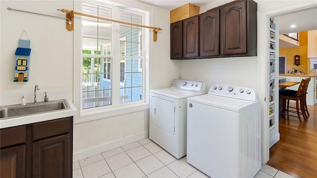 14559 Zimmerman Ln, Rogers, AR 72756 - laundry room with separate washer and dryer, cabinet space, light tile patterned floors, and baseboards