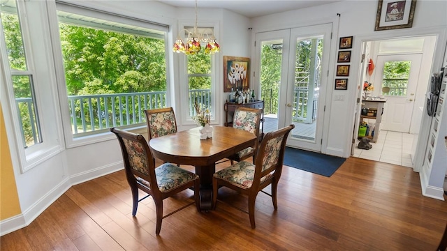 14559 Zimmerman Ln, Rogers, AR 72756 - dining area featuring a chandelier, wood finished floors, and baseboards