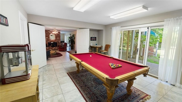 14559 Zimmerman Ln, Rogers, AR 72756 - game room with billiards table, a brick fireplace, ceiling fan, and light tile patterned floors