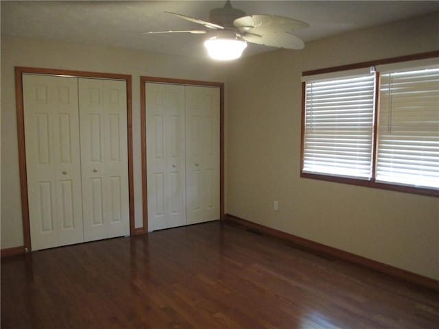 9 Rancho Vista Ln, Holiday Island, AR 72631 - unfurnished bedroom with two closets, wood finished floors, and a ceiling fan
