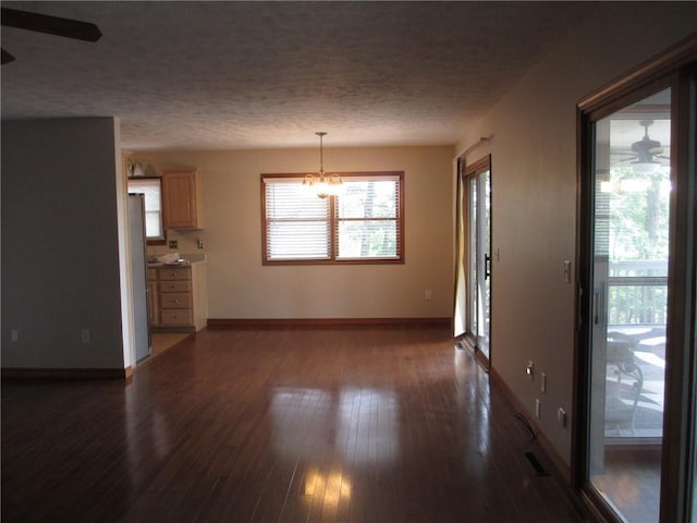 9 Rancho Vista Ln, Holiday Island, AR 72631 - unfurnished living room with dark wood-style floors, a textured ceiling, a chandelier, and a ceiling fan