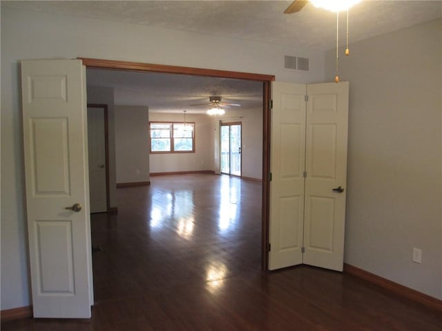 9 Rancho Vista Ln, Holiday Island, AR 72631 - unfurnished room featuring a ceiling fan and dark wood-style floors