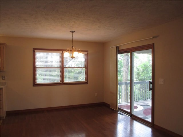 9 Rancho Vista Ln, Holiday Island, AR 72631 - unfurnished dining area featuring wood finished floors, a chandelier, and a textured ceiling