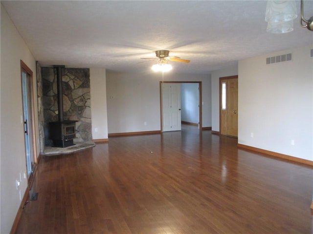 9 Rancho Vista Ln, Holiday Island, AR 72631 - unfurnished living room with wood finished floors, ceiling fan, and a wood stove