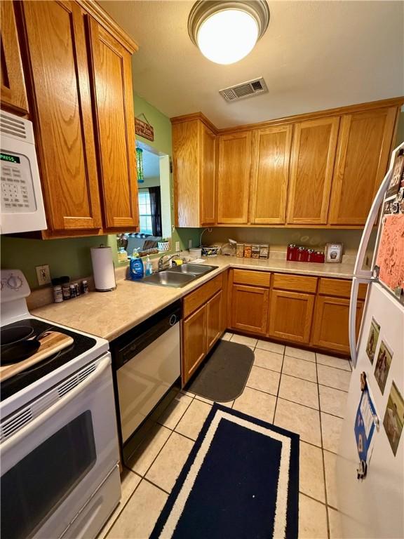 23933 J M Summers Rd, Summers, AR 72769 - kitchen featuring white appliances, a sink, light countertops, and light tile patterned floors