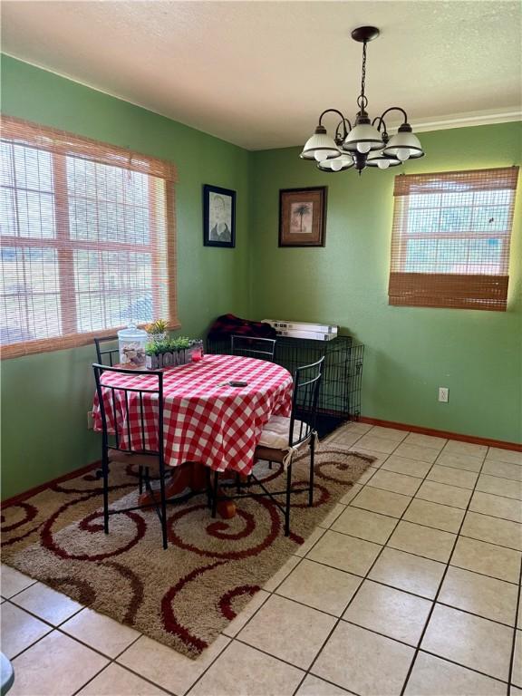 23933 J M Summers Rd, Summers, AR 72769 - dining space featuring light tile patterned floors, a chandelier, and baseboards