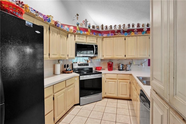 4 Branchwood Ln, Bella Vista, AR 72715 - kitchen with black appliances, vaulted ceiling, light tile patterned flooring, decorative backsplash, and light countertops