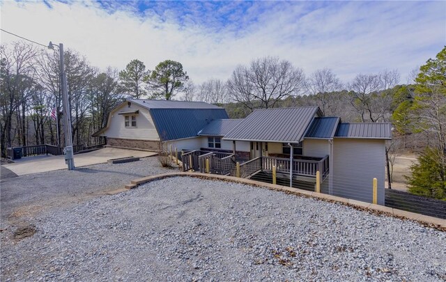 2480 N Saint Andrews Dr, Kansas, OK 74347 - view of front facade with metal roof, a porch, and driveway