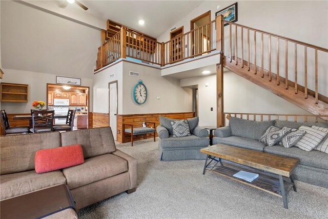2480 N Saint Andrews Dr, Kansas, OK 74347 - living room with carpet flooring, high vaulted ceiling, stairway, and a ceiling fan