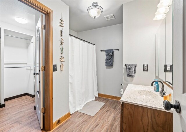 2480 N Saint Andrews Dr, Kansas, OK 74347 - full bathroom featuring vanity, wood finished floors, baseboards, and curtained shower
