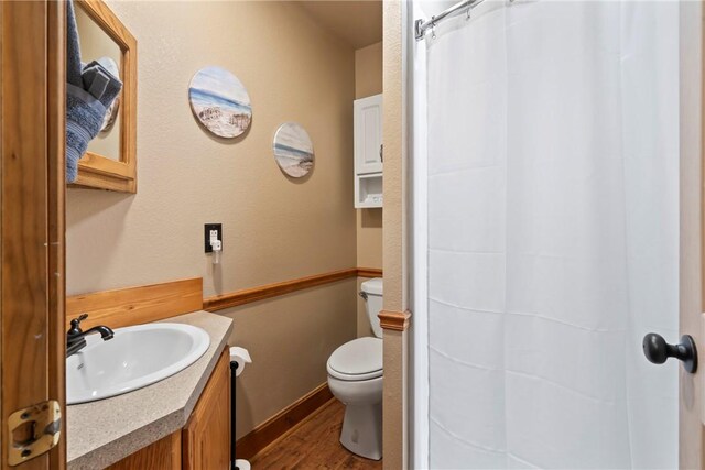 2480 N Saint Andrews Dr, Kansas, OK 74347 - full bathroom with vanity, toilet, wood finished floors, and curtained shower