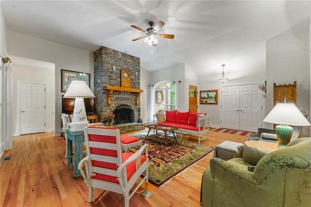 47 Rath Dr, Bella Vista, AR 72715 - living room featuring a ceiling fan, light wood finished floors, a fireplace, baseboards, and lofted ceiling
