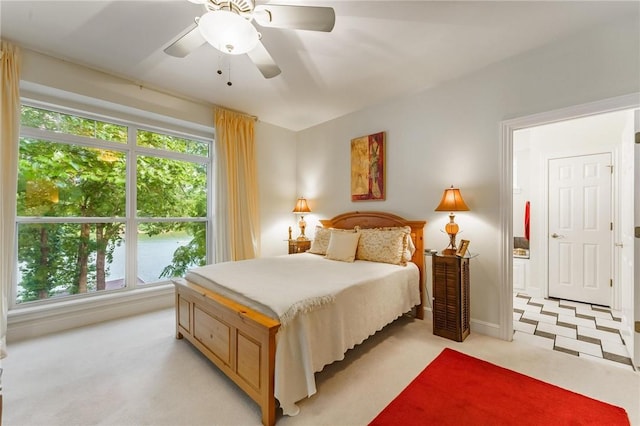 47 Rath Dr, Bella Vista, AR 72715 - bedroom with multiple windows, light colored carpet, baseboards, and ceiling fan