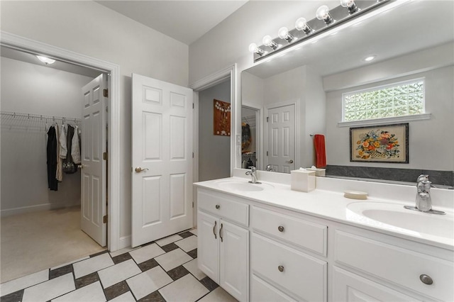 47 Rath Dr, Bella Vista, AR 72715 - bathroom featuring double vanity, tile patterned floors, and a spacious closet