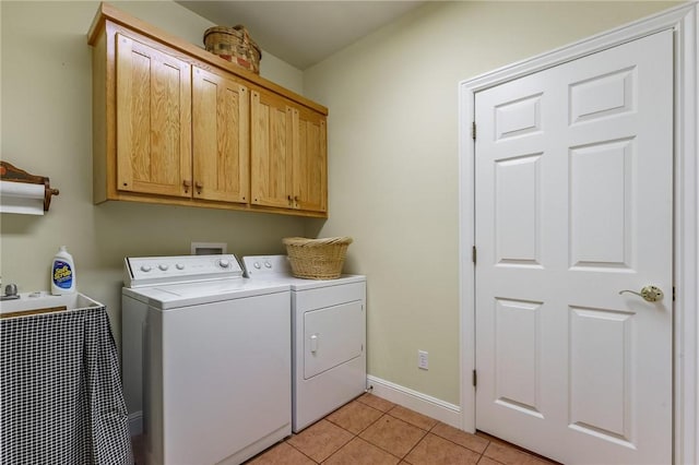 47 Rath Dr, Bella Vista, AR 72715 - washroom with washing machine and dryer, cabinet space, light tile patterned flooring, and baseboards