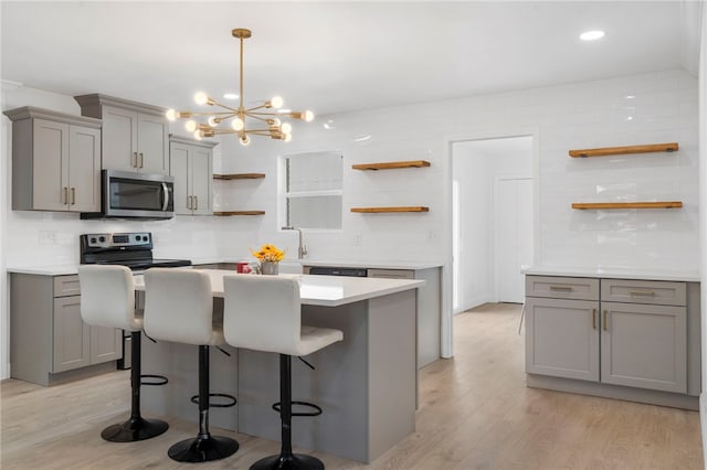 1089 Elway Dr, Springdale, AR 72764 - kitchen featuring open shelves, stainless steel appliances, gray cabinetry, light wood-style flooring, and recessed lighting