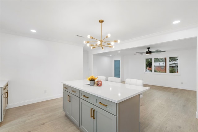1089 Elway Dr, Springdale, AR 72764 - kitchen featuring a chandelier, a kitchen island, gray cabinetry, light countertops, and light wood finished floors