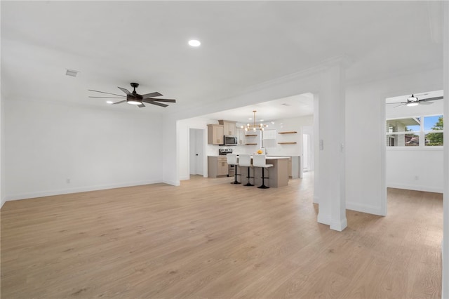 1089 Elway Dr, Springdale, AR 72764 - unfurnished living room featuring a chandelier, ceiling fan, baseboards, light wood finished floors, and recessed lighting