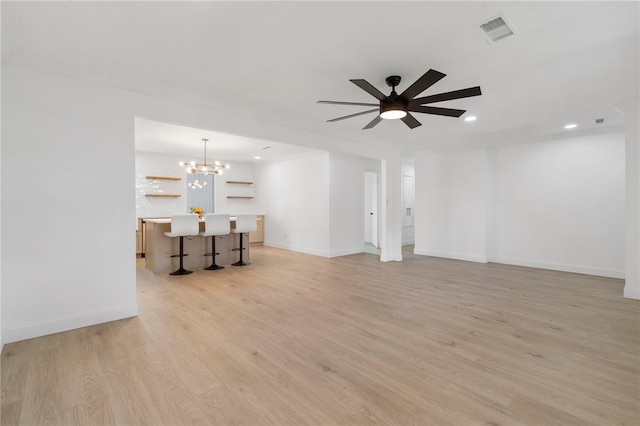 1089 Elway Dr, Springdale, AR 72764 - unfurnished living room featuring light wood finished floors, a chandelier, baseboards, and recessed lighting