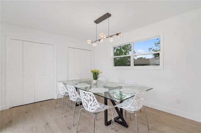 1089 Elway Dr, Springdale, AR 72764 - dining room featuring wood finished floors, baseboards, and a chandelier
