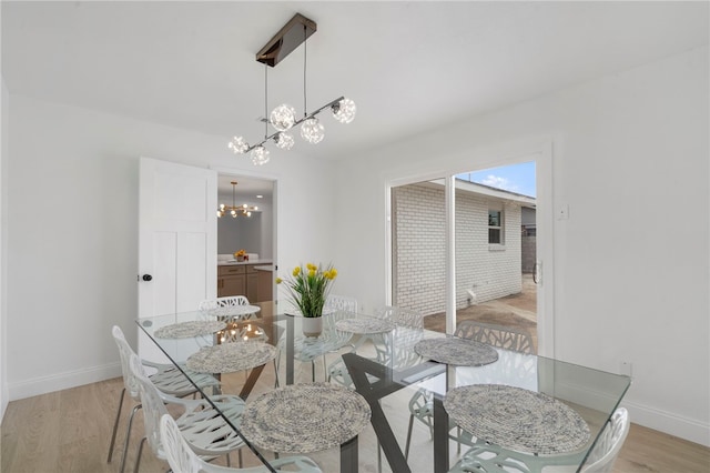 1089 Elway Dr, Springdale, AR 72764 - dining area featuring light wood-style flooring, a chandelier, and baseboards