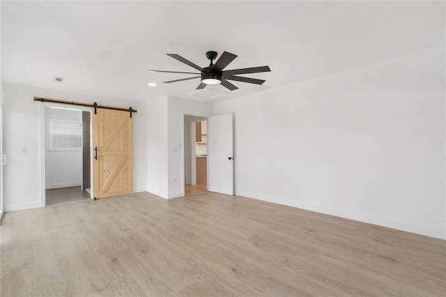 1089 Elway Dr, Springdale, AR 72764 - unfurnished bedroom with a barn door, a spacious closet, baseboards, and recessed lighting