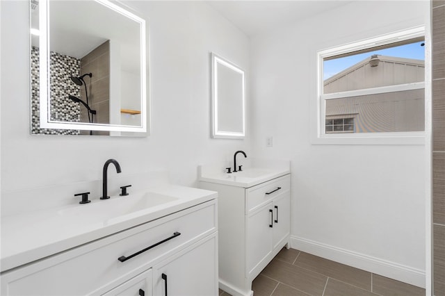 1089 Elway Dr, Springdale, AR 72764 - bathroom with two vanities, baseboards, and tiled shower