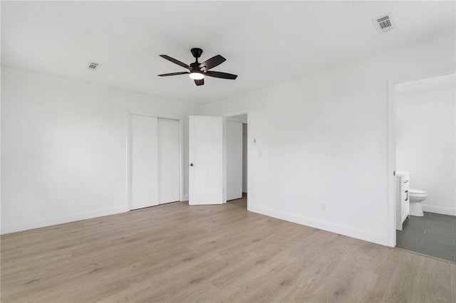 1089 Elway Dr, Springdale, AR 72764 - unfurnished bedroom featuring baseboards, light wood finished floors, ensuite bathroom, a closet, and ceiling fan