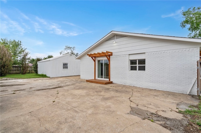 1089 Elway Dr, Springdale, AR 72764 - rear view of property featuring brick siding, a patio, and a pergola