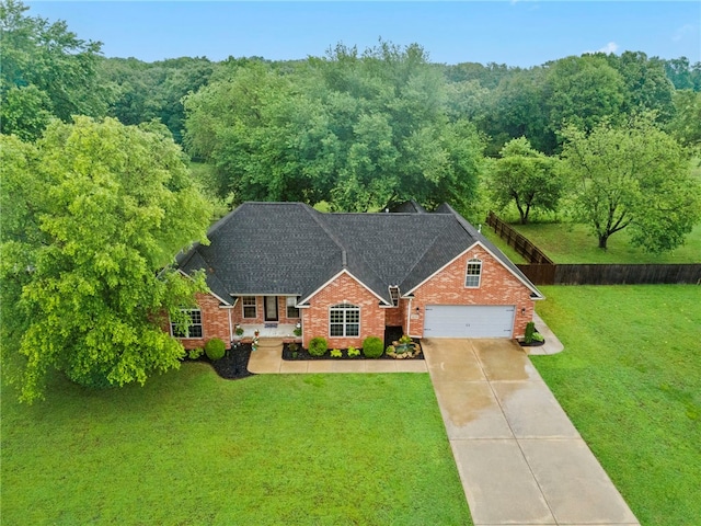22704 Oakview Rd, Siloam Springs, AR 72761 - traditional-style house featuring concrete driveway, brick siding, an attached garage, roof with shingles, and a view of trees