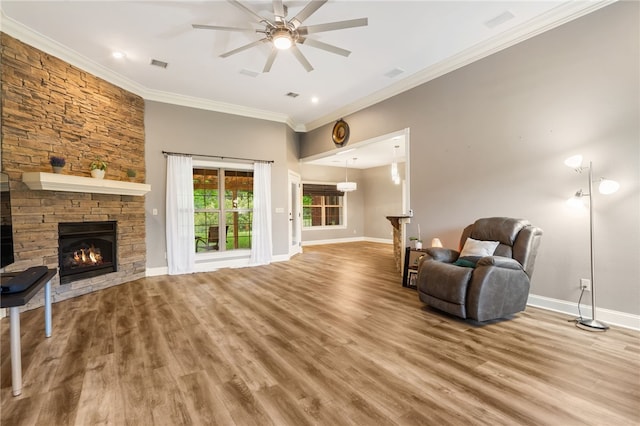 22704 Oakview Rd, Siloam Springs, AR 72761 - sitting room featuring a fireplace, ceiling fan, crown molding, wood finished floors, and baseboards