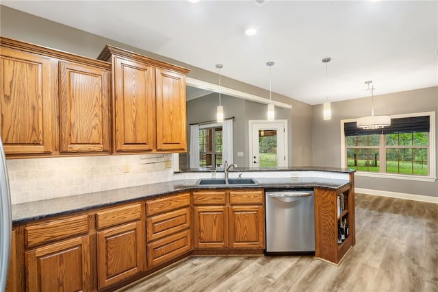 22704 Oakview Rd, Siloam Springs, AR 72761 - kitchen with dishwasher, a sink, brown cabinetry, light wood finished floors, and decorative backsplash