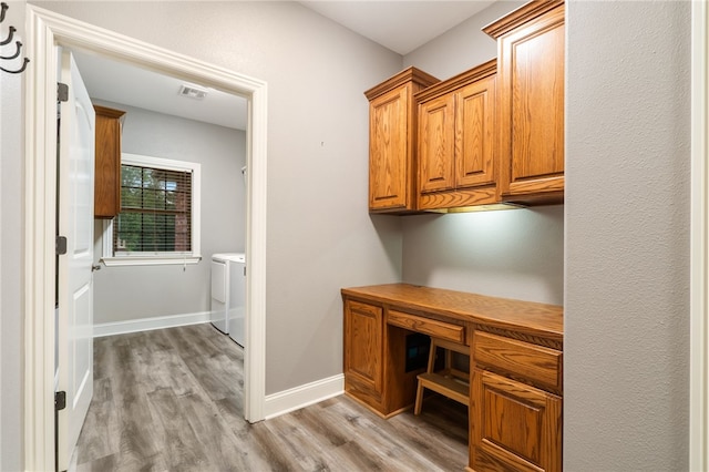 22704 Oakview Rd, Siloam Springs, AR 72761 - unfurnished office featuring light wood-style floors, washing machine and dryer, baseboards, and built in study area