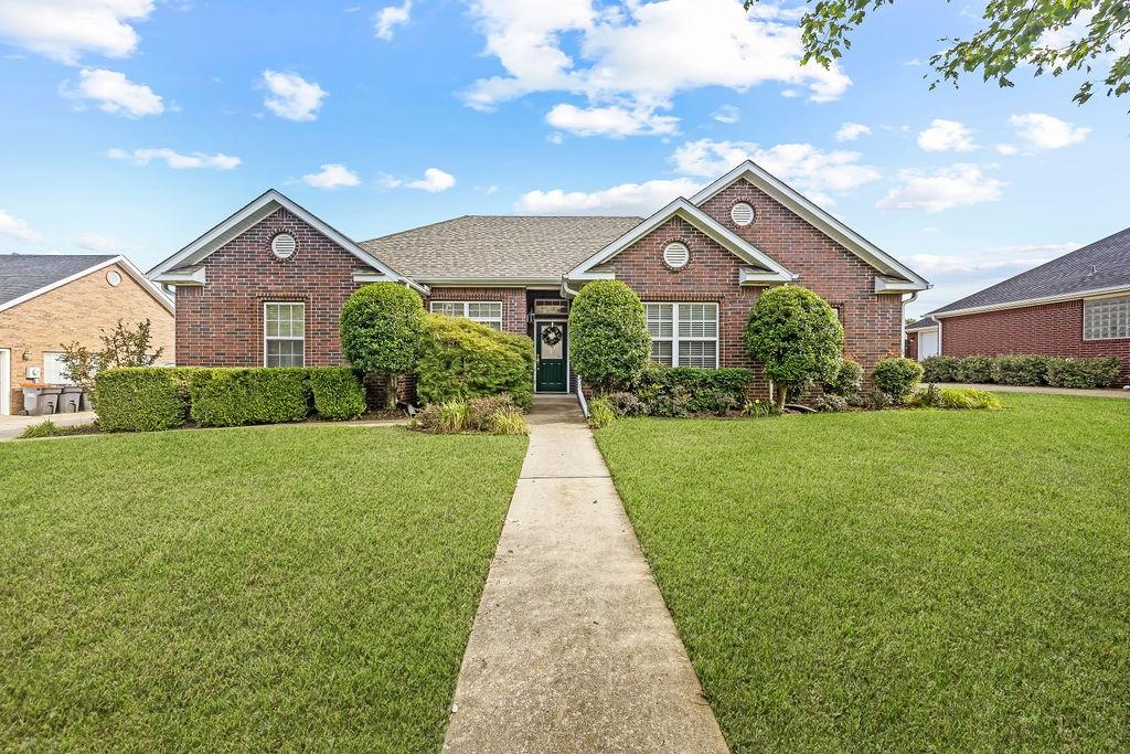 6454 Norman, Springdale, AR 72762 - view of front facade featuring brick siding and a front yard