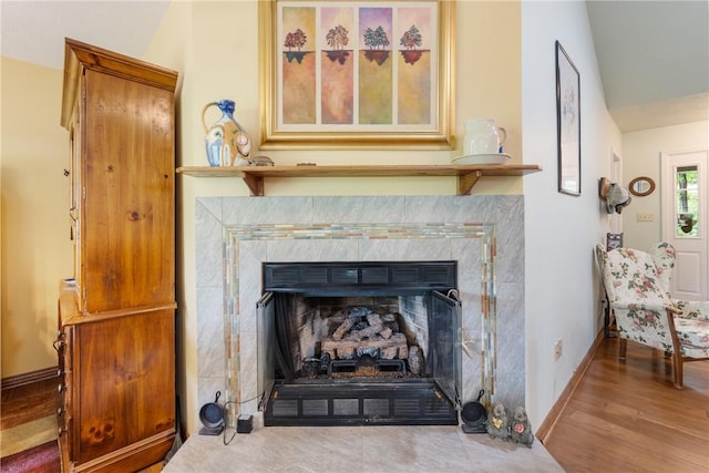 16 Osage Ln, Holiday Island, AR 72631 - detailed view of a fireplace with flush hearth, wood finished floors, and baseboards