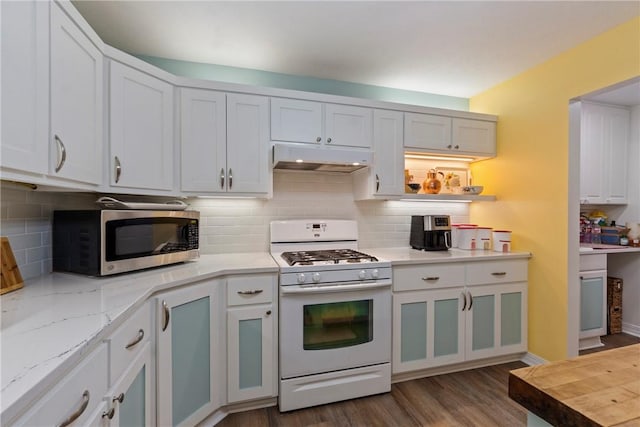 16 Osage Ln, Holiday Island, AR 72631 - kitchen featuring white range with gas cooktop, stainless steel microwave, under cabinet range hood, dark wood-type flooring, and white cabinetry
