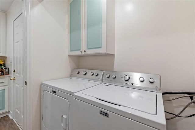 16 Osage Ln, Holiday Island, AR 72631 - laundry room with cabinet space, washer and clothes dryer, and wood finished floors