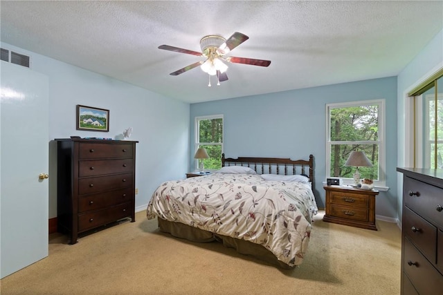 16 Osage Ln, Holiday Island, AR 72631 - bedroom featuring light colored carpet, multiple windows, a ceiling fan, a closet, and a textured ceiling