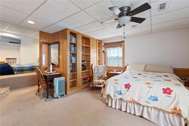 16 Osage Ln, Holiday Island, AR 72631 - carpeted bedroom featuring wooden walls, radiator, and ceiling fan