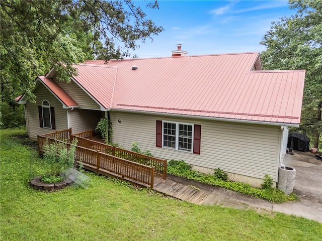 16 Osage Ln, Holiday Island, AR 72631 - rear view of property featuring a chimney, a wooden deck, a lawn, and metal roof