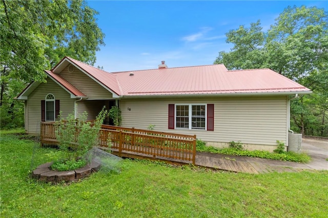 16 Osage Ln, Holiday Island, AR 72631 - back of house featuring a wooden deck, a lawn, and metal roof