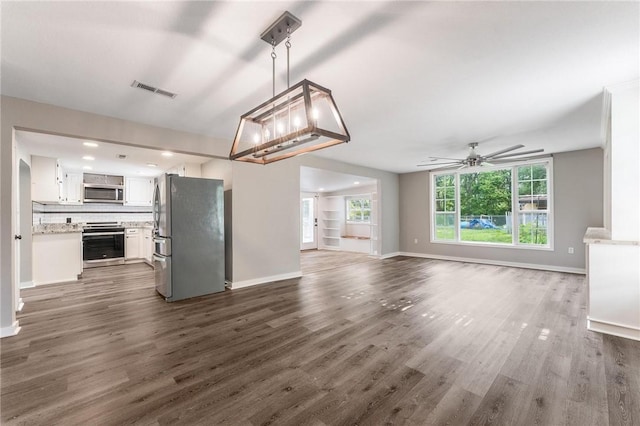 2182 Shumate, Springdale, AR 72762 - unfurnished living room with ceiling fan, dark wood finished floors, and baseboards