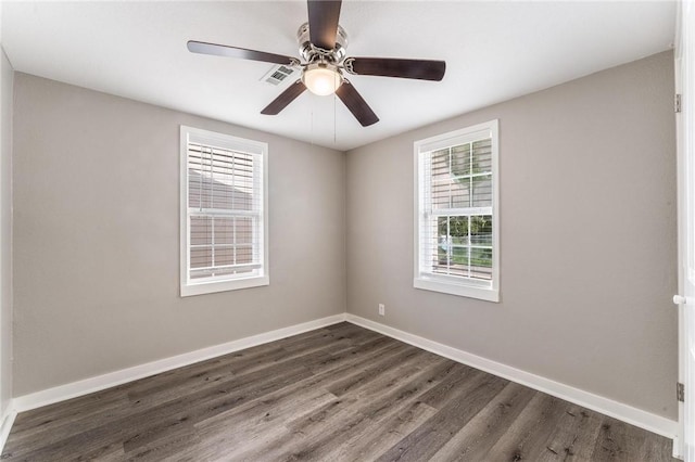 2182 Shumate, Springdale, AR 72762 - unfurnished room featuring dark wood-type flooring, baseboards, and ceiling fan