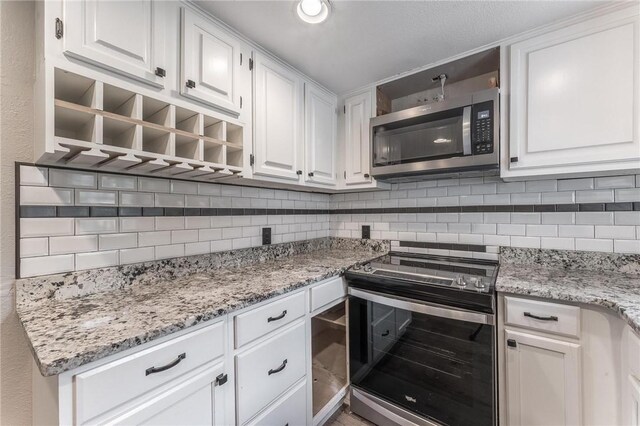 2182 Shumate, Springdale, AR 72762 - kitchen with stainless steel appliances, tasteful backsplash, white cabinetry, and light stone countertops