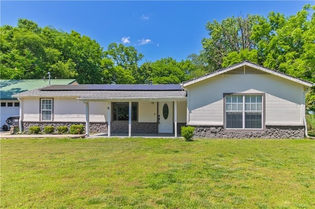 2182 Shumate, Springdale, AR 72762 - view of front of property featuring stone siding, a front yard, solar panels, and a garage