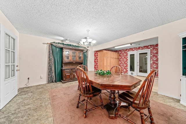 634 Orchard View Ests, Alma, AR 72921 - dining area with a chandelier, a textured ceiling, light carpet, and baseboards