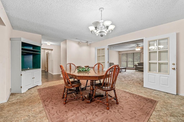 634 Orchard View Ests, Alma, AR 72921 - dining area with a chandelier, a textured ceiling, light carpet, track lighting, and baseboards