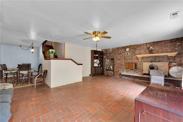 320 S Pleasant St, Springdale, AR 72764 - living area with ceiling fan, brick wall, and brick flooring